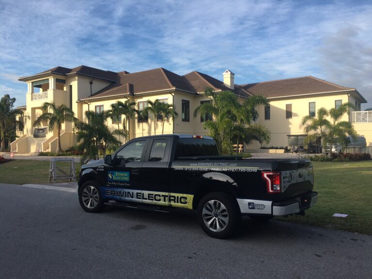 Electric company truck parked by mansion