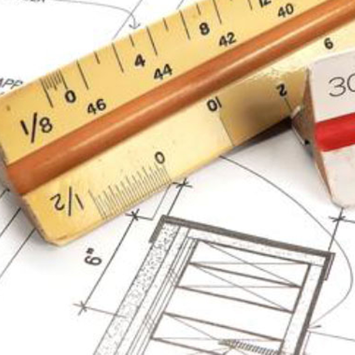Architectural scale ruler and pencil on blueprint