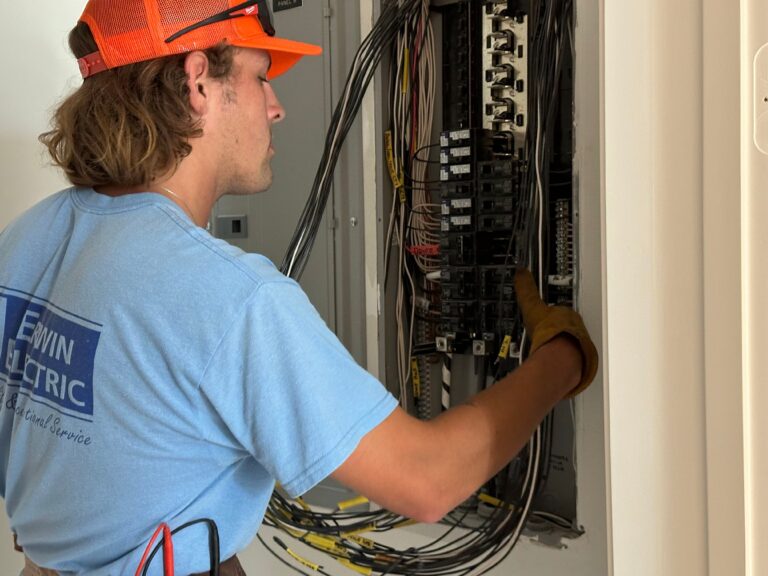 Electrician inspecting residential electrical panel